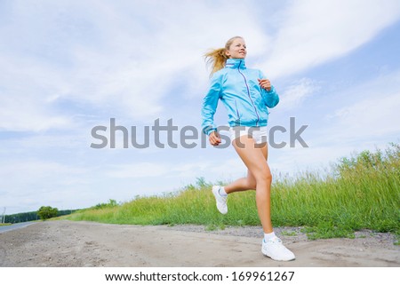 Young beautiful girl training outdoor in summer