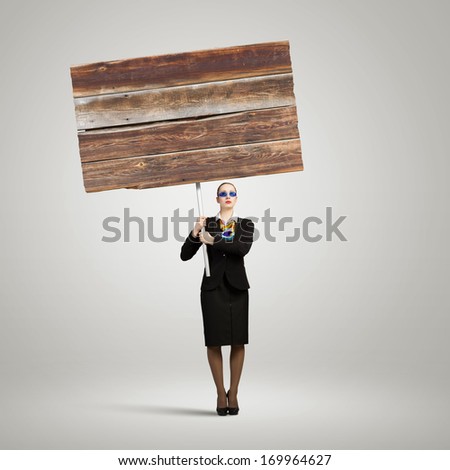 Image of businesswoman holding blank wooden banner. Place for text