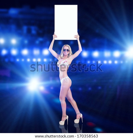 Attractive girl in swimming suit holding white blank banner above head