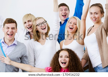 Young happy people in classroom screaming joyfully