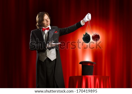 Image of magician showing tricks with hat