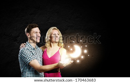 Conceptual image of young couple hugging each other and dreaming