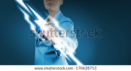 Image of powerful businesswoman holding lightning in fist