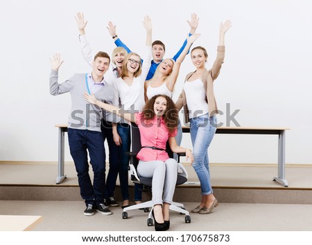 Young happy people in classroom screaming joyfully