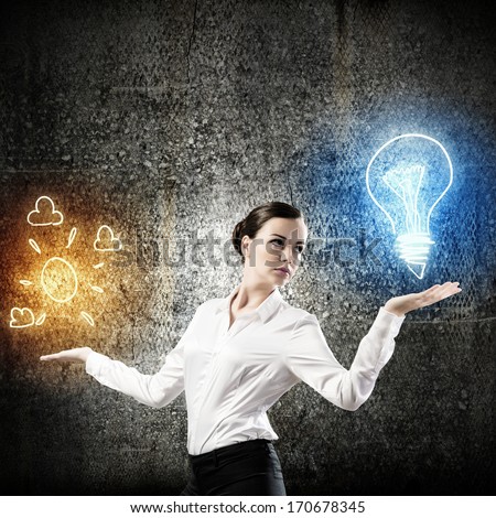 Image of young businesswoman holding bulb on palm