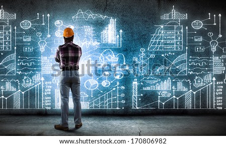 Image Of Man Builder Looking At Media Screen