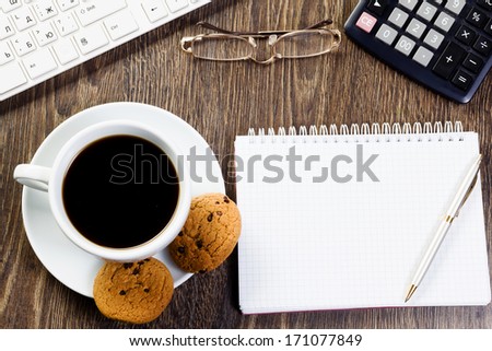 Business work place with cup of coffee calculator and glasses