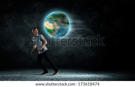 Young man against dark running from Earth planet. Elements of this image are furnished by NASA