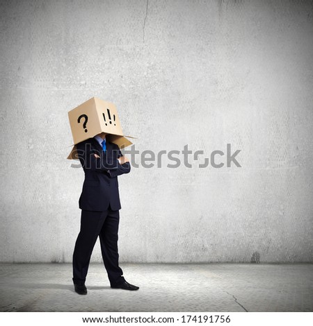 Businessman with box on head expressing emotions