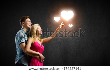 Conceptual image of young couple hugging each other and dreaming