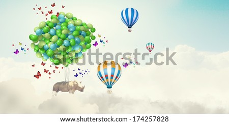 Sunny image of giraffe flying high in sky on aerostat