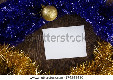 White blank card with decoration balls and tinsel. Place for text