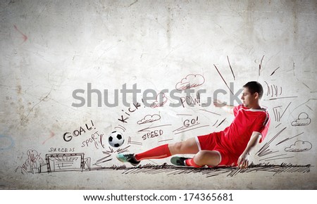 Football player in jump striking ball with sketches at backdrop