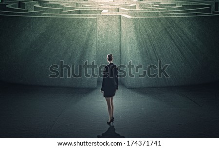 Businesswoman standing near the enter of labyrinth