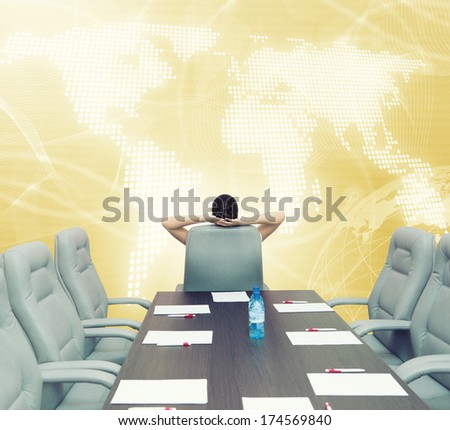 Businesswoman boss in conference room sitting with back in chair
