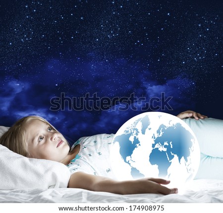 Girl in bed with Earth planet in hands