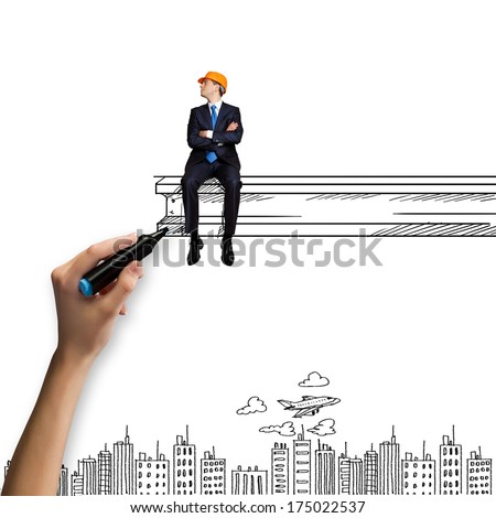 Businessman in helmet sitting on construction beam