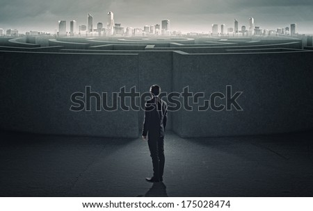Businessman standing near the enter of labyrinth
