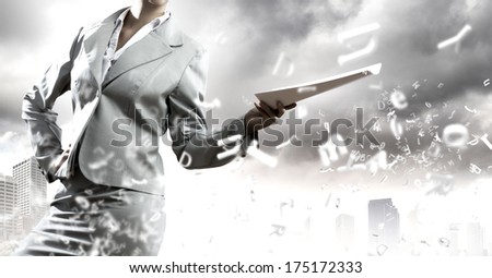 Close up of businesswoman holding papers in hands
