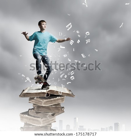 Boy skater standing on pile of old books
