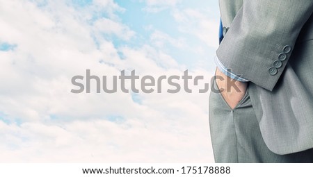 Close up of confident businessman with hands in pockets