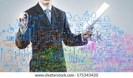 Close up of businessman with documents in hand drawing business sketches