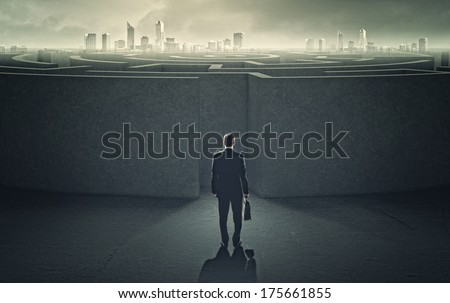 Businessman standing near the enter of labyrinth