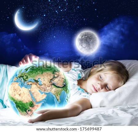 Girl in bed with Earth planet in hands.