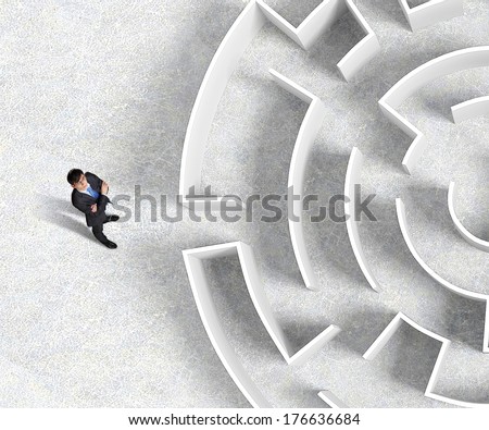 Top view of businessman standing near the enter of labyrinth
