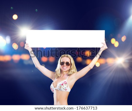 Attractive girl in swimming suit with white blank banner. Place for text