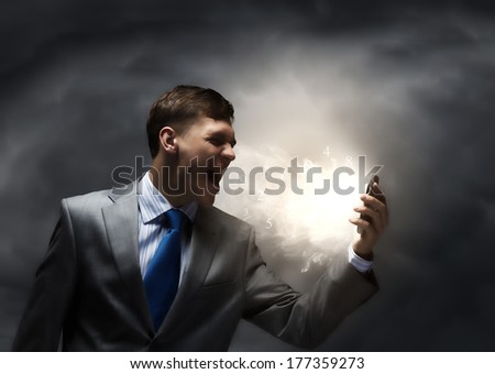 Angry businessman screaming furiously in to mobile phone