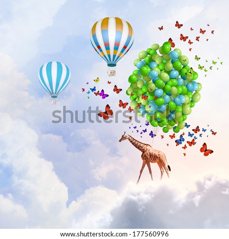 Sunny image of giraffe flying high in sky on aerostat