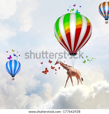 Giraffe flying high in sky on colorful aerostat