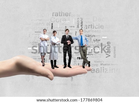 Business people of different professions standing on palm