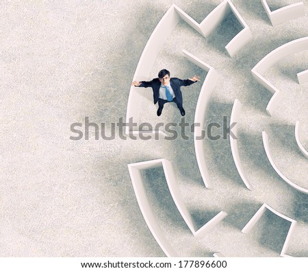 Top view of successful businessman lost in labyrinth