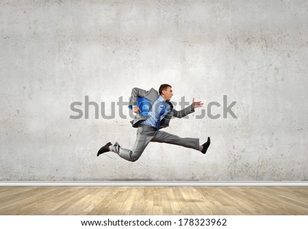 Young businessman in room running in a hurry