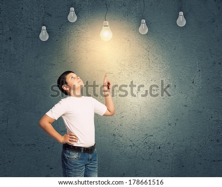 School boy and electric bulbs hanging above