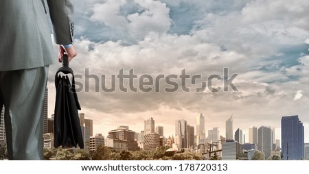 Back view of businessman with suitcase in hand