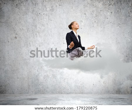 Young attractive lady sitting on cloud and practicing yoga