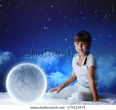Cute girl sitting in bed with moon