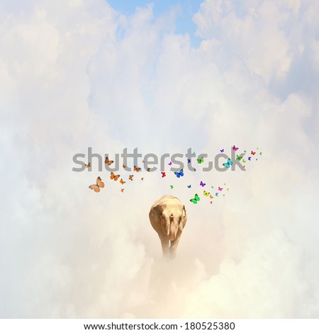 Elephant flying in sky among colorful butterflies