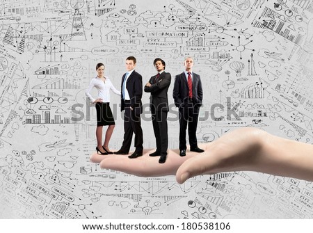 Business people of different professions standing on palm