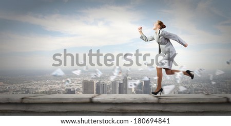 Young businesswoman in suit running in a hurry