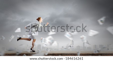 Young businesswoman in suit running in a hurry