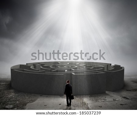 Rear view of businessman entering round white labyrinth