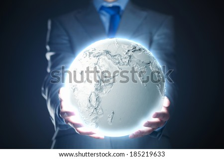 Young man in suit holding moon in palm