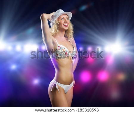 Attractive girl in swim wear dancing in party lights