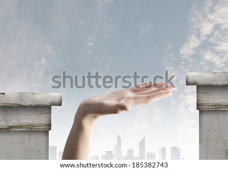Close up of human hand between bridge gap