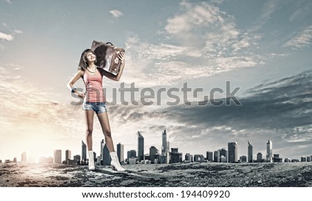 Young pretty woman tourist walking with suitcase