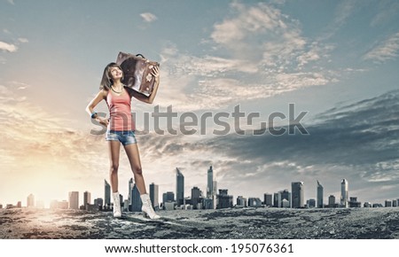 Young pretty woman tourist walking with suitcase